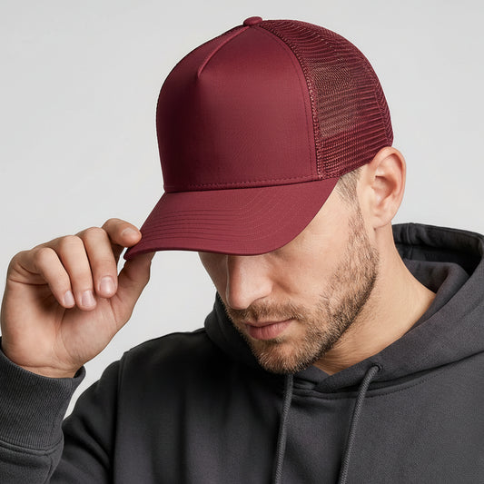 Man wearing a maroon cap with a visible brand logo against a plain background