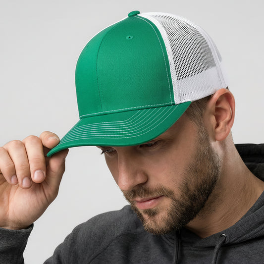 Man wearing a green and white cap with a gray hoodie on a light gray background