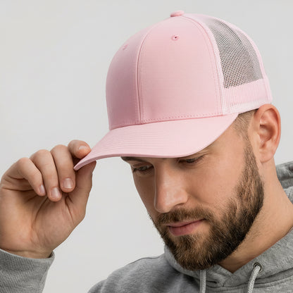 Man wearing a pink cap with a logo and a gray hoodie on a light gray background