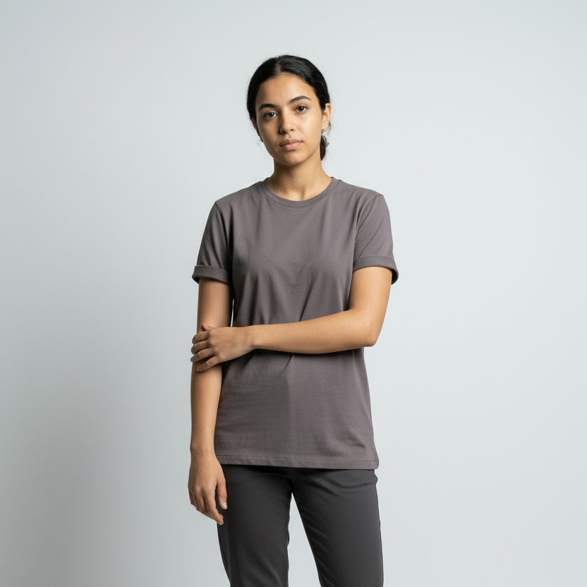 Person wearing a plain gray t-shirt against a light gray background