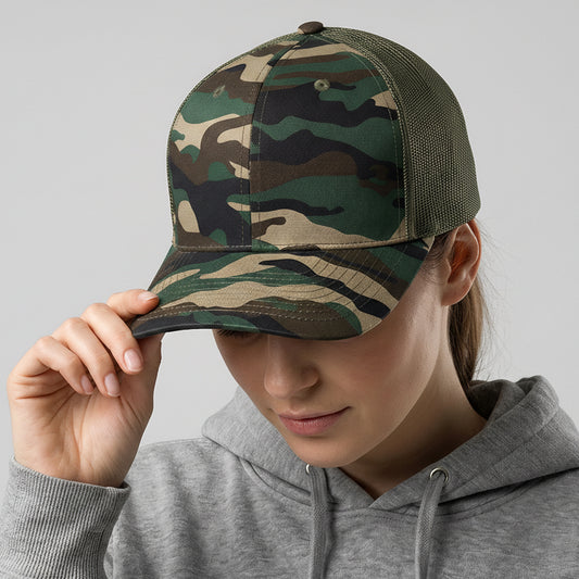 Person wearing a camouflage cap and gray hoodie on a light gray background