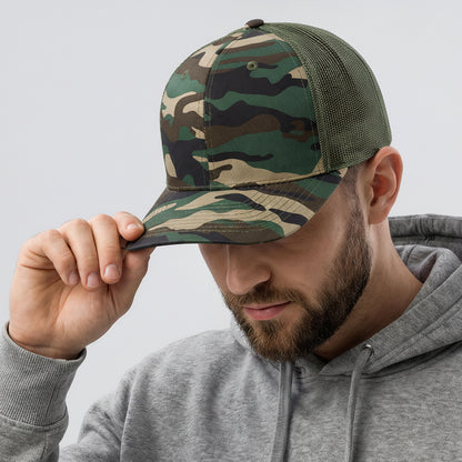 Man wearing a camouflage cap with a logo on a light gray background