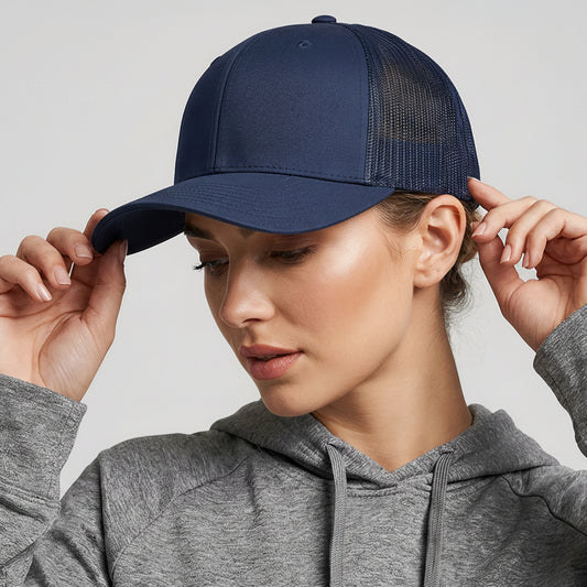 Person wearing a navy blue cap with a colorful logo on a light gray background