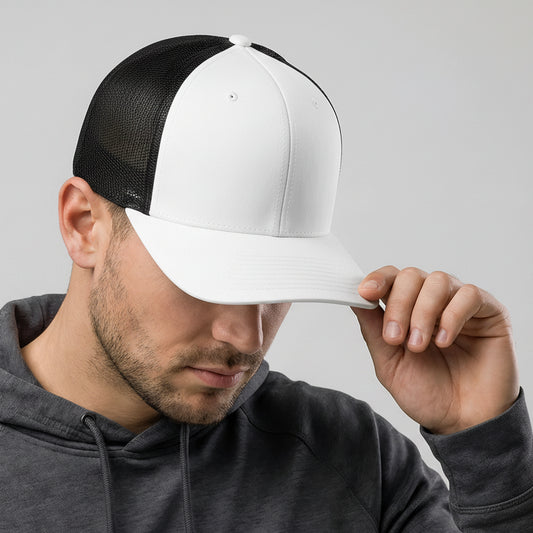 Man wearing a black and white cap with a gray hoodie on a light gray background