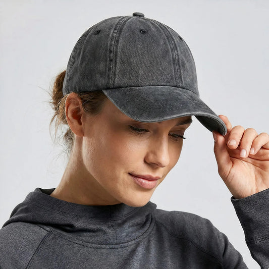 Person wearing a gray cap and hoodie against a light gray background