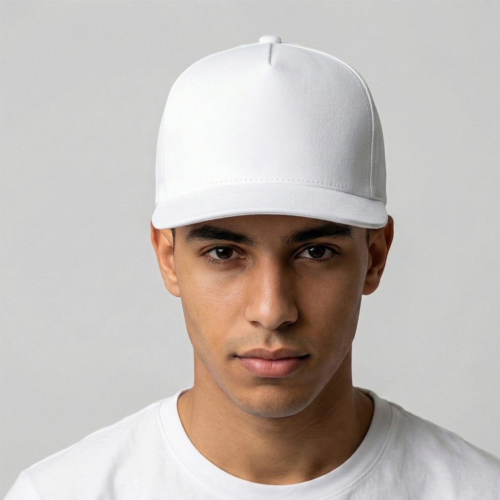 Person wearing a white cap and white shirt against a gray background