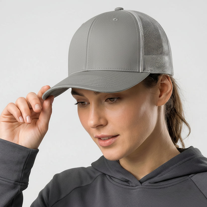 Person wearing a gray cap and matching hoodie against a plain background