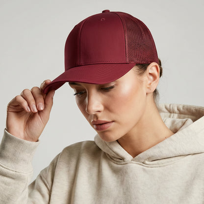 Person wearing a maroon cap and beige hoodie against a plain background