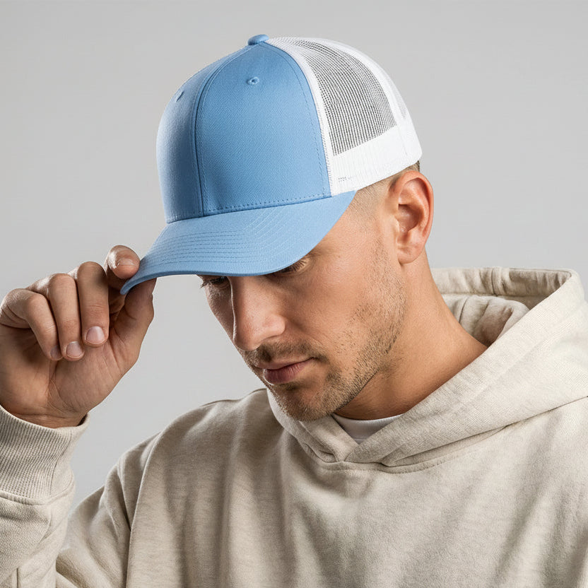 Man wearing a blue and white cap with a gray background