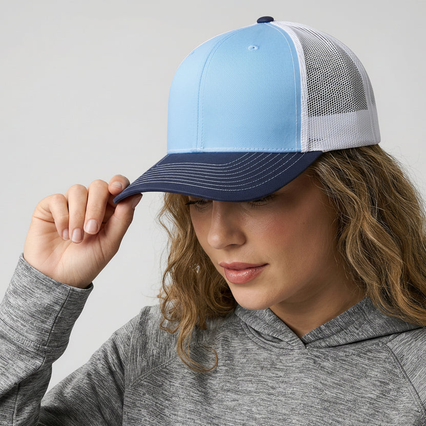 Person wearing a blue and white cap with a visible brand logo on a plain background