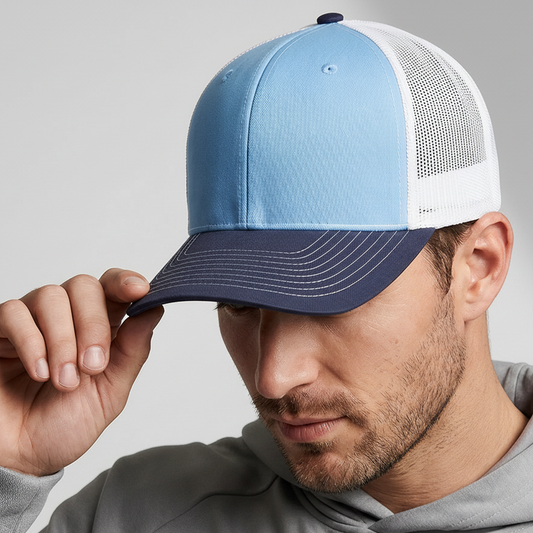 Man wearing a blue and white cap on a gray background