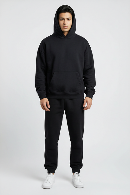 Person wearing a white hoodie and pants on a light gray background