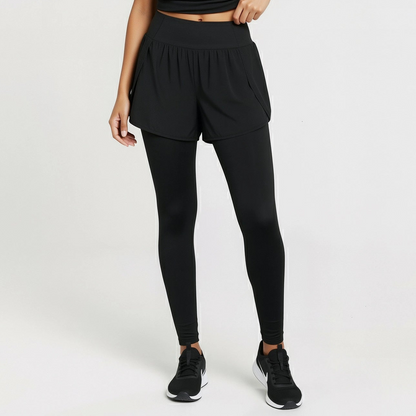 Woman wearing a black athletic outfit on a white background