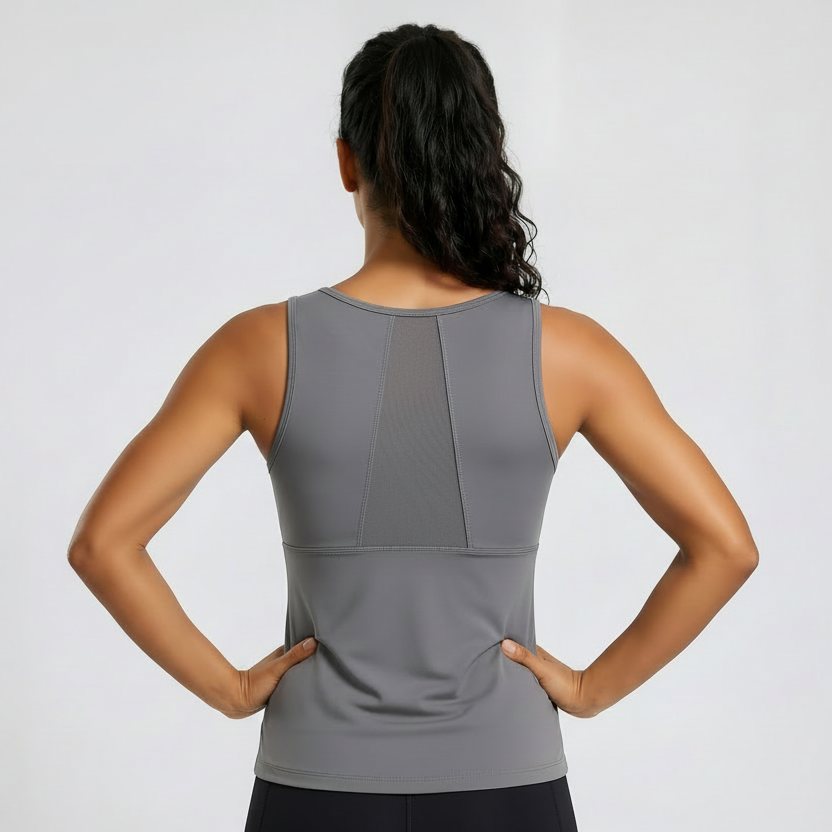 Woman wearing a gray sleeveless top on a white background