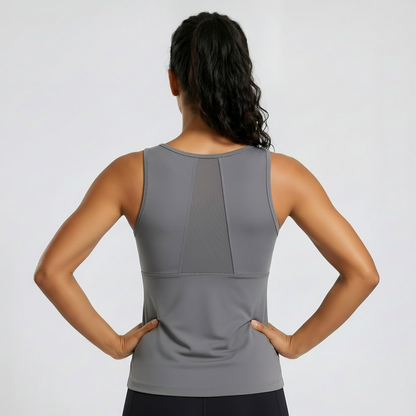 Woman wearing a gray sleeveless top on a white background