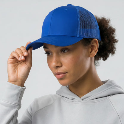 Person wearing a blue cap and gray hoodie against a light gray background