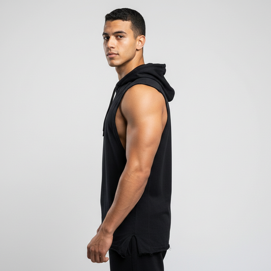 Man wearing a black sleeveless hoodie on a light gray background