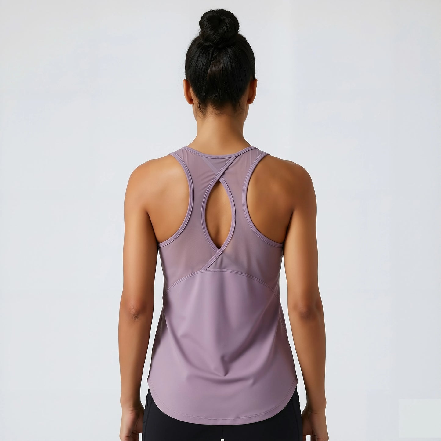 Person wearing a light purple tank top with a white background