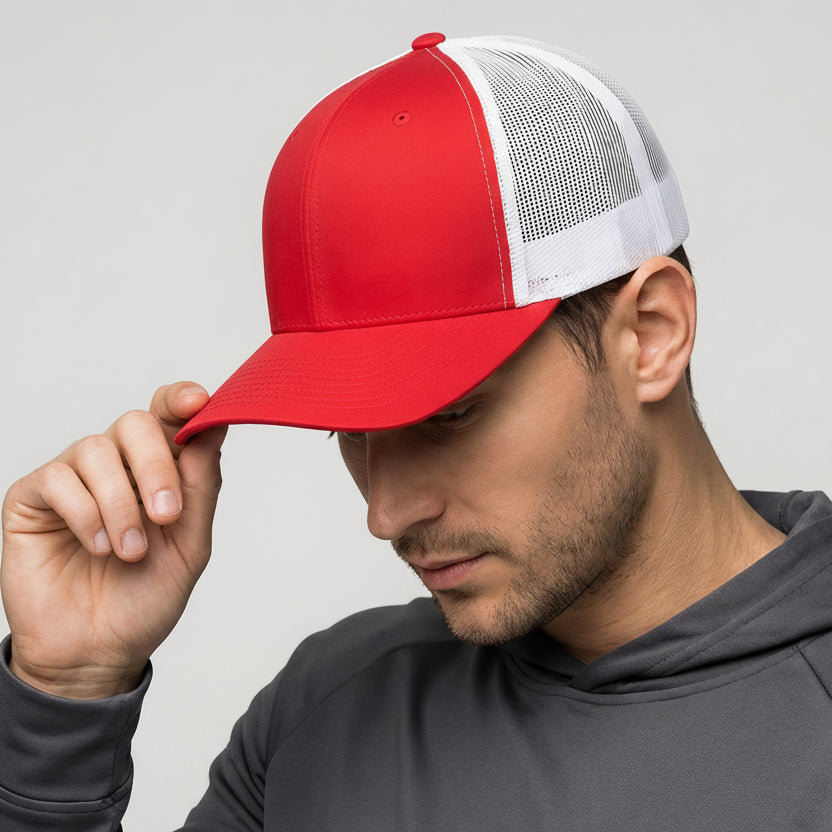 Man wearing a red and white cap with a gray hoodie on a light gray background