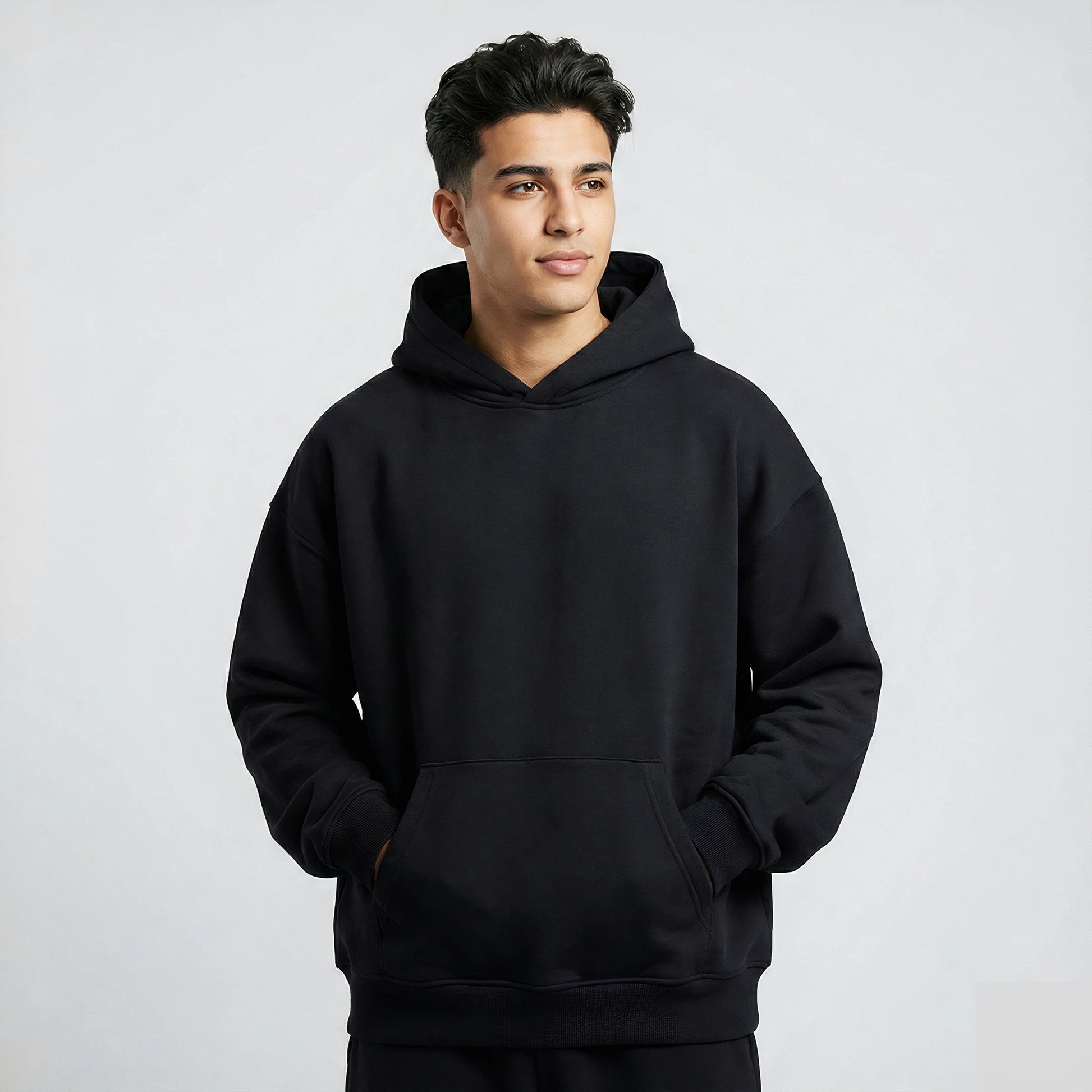 Man wearing a black hoodie against a plain background