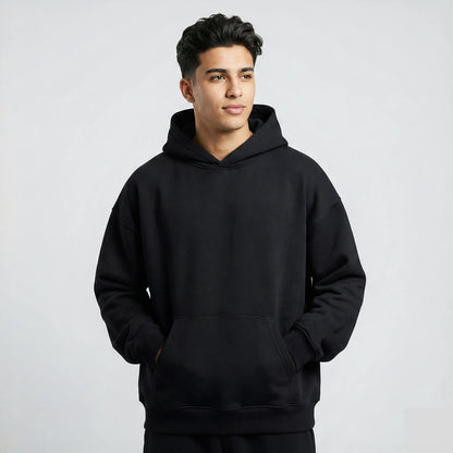 Man wearing a black hoodie against a plain background