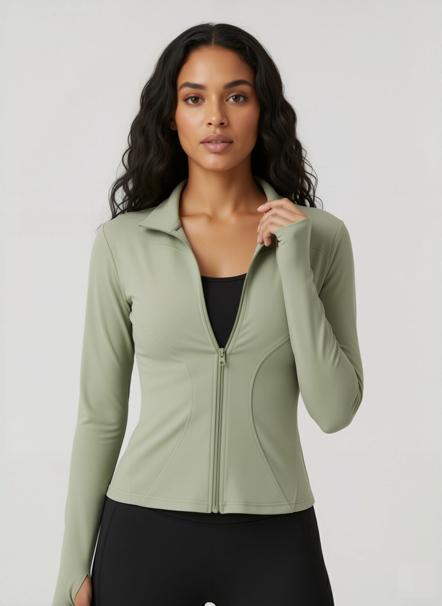 Woman wearing a green athletic jacket on a white background