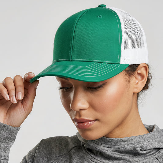 Person wearing a green and white cap with a gray hoodie on a light gray background