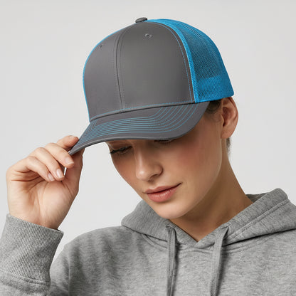 Person wearing a gray cap with blue visor and a gray hoodie on a light gray background