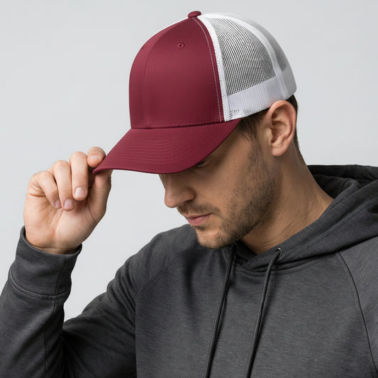 Man wearing a maroon and gray cap with a gray hoodie on a light gray background