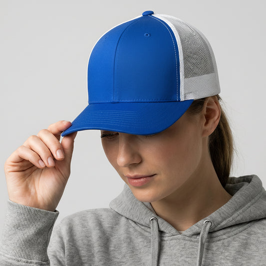 Person wearing a blue and white cap with a gray hoodie on a light gray background