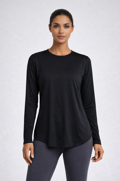 Woman wearing a black long-sleeve top and gray leggings on a white background