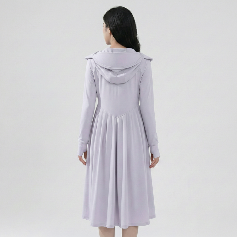 Woman wearing a light purple dress with a hood on a white background
