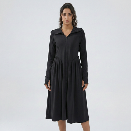 Woman wearing a black dress with a hood on a white background