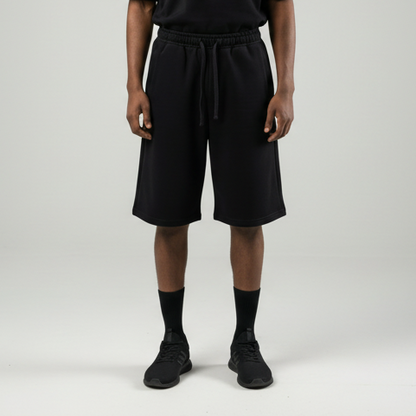 Person wearing a black outfit on a gray background