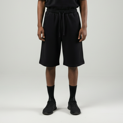 Person wearing a black outfit on a gray background