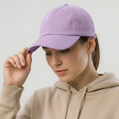 Person wearing a purple cap and beige hoodie on a light gray background